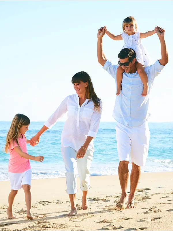 Family on the beach with life and health insurance coverage